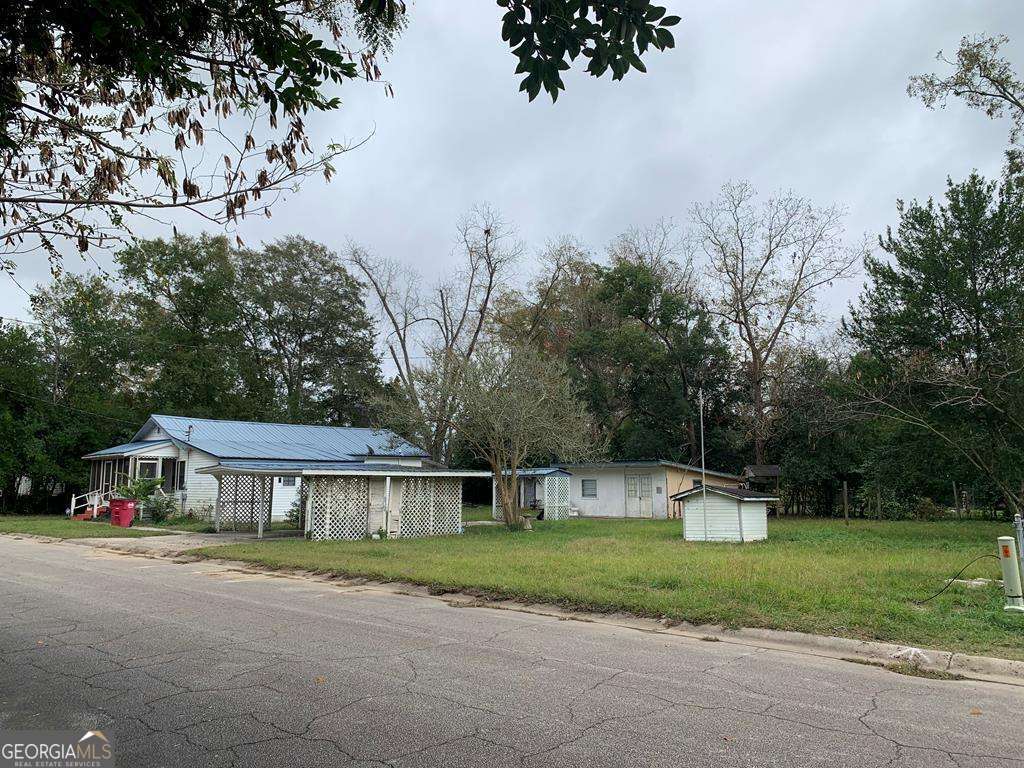 a front view of house with yard and green space