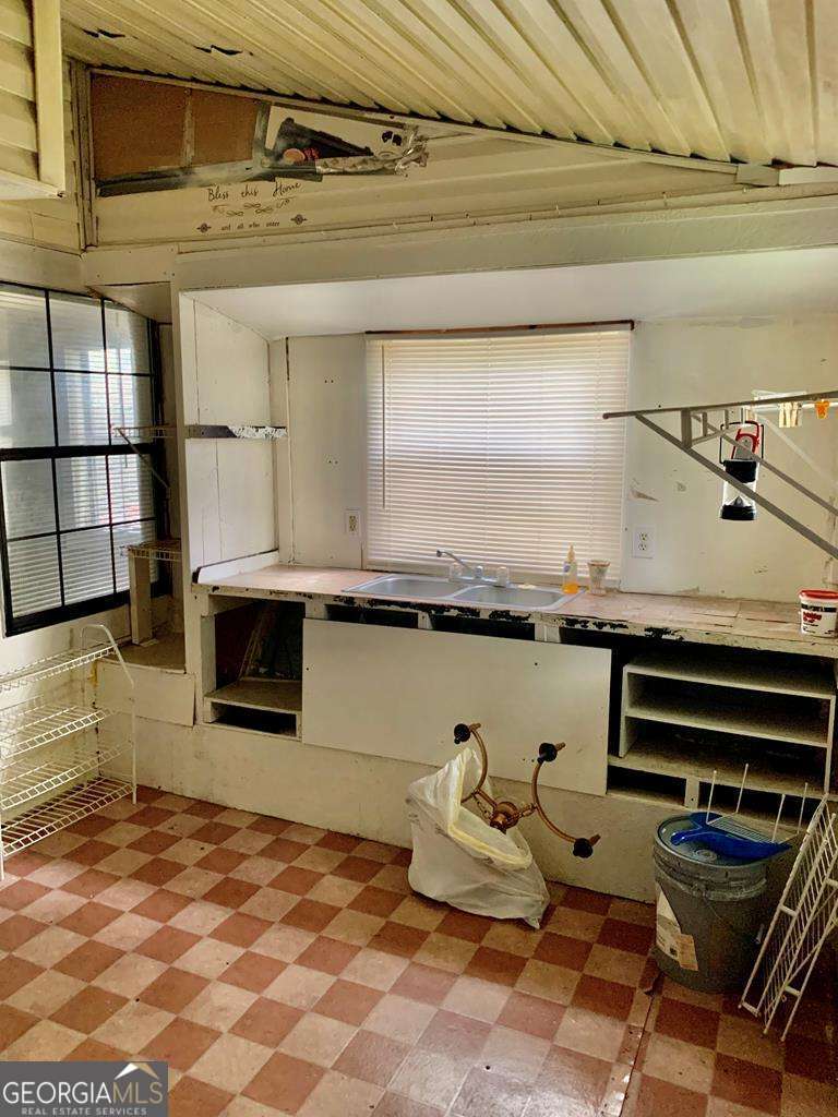 606 West 7th Street Alma, GA 31510 - Photo 24 of 28 a kitchen with a stove and a microwave