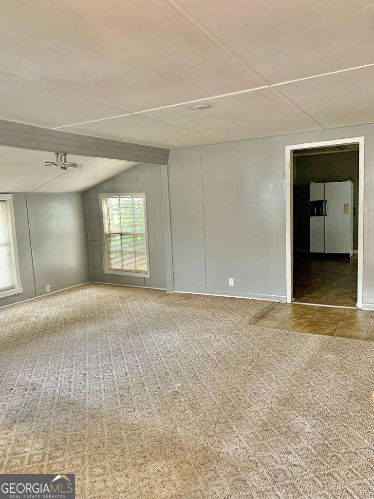 606 West 7th Street Alma, GA 31510 - Photo 7 of 28 an empty room with a empty space and windows