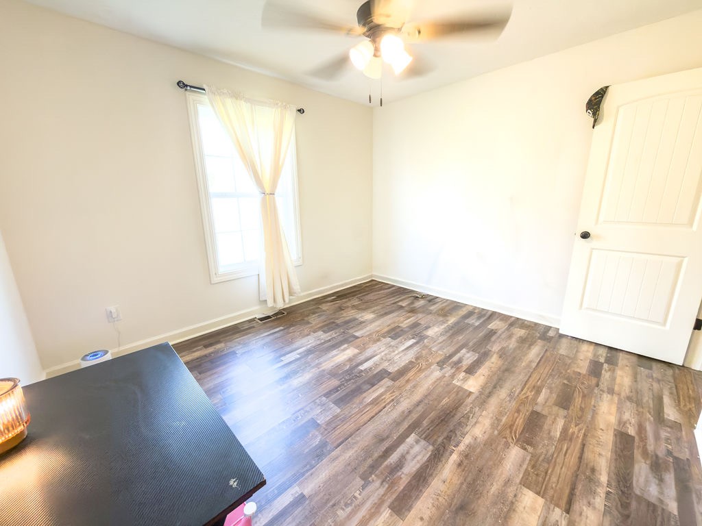 392 Scott Road Sharon Grove, KY 42280 - Photo 14 of 36 an empty room with wooden floor fan and windows