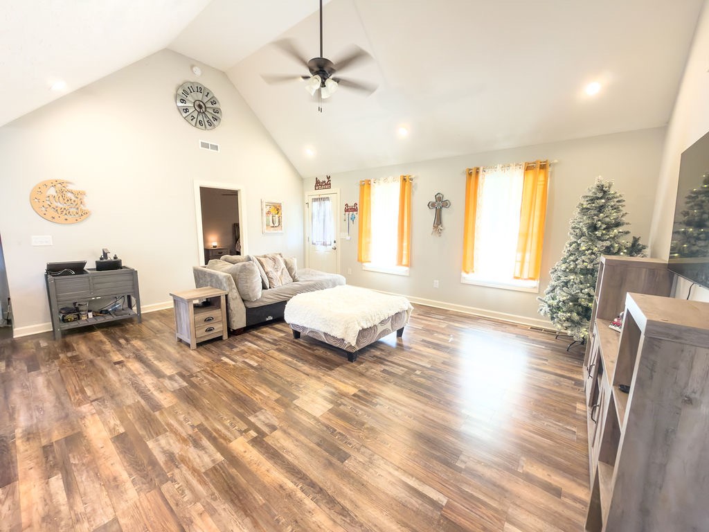 392 Scott Road Sharon Grove, KY 42280 - Photo 15 of 36 a spacious bedroom with a bed a couch and a chandelier