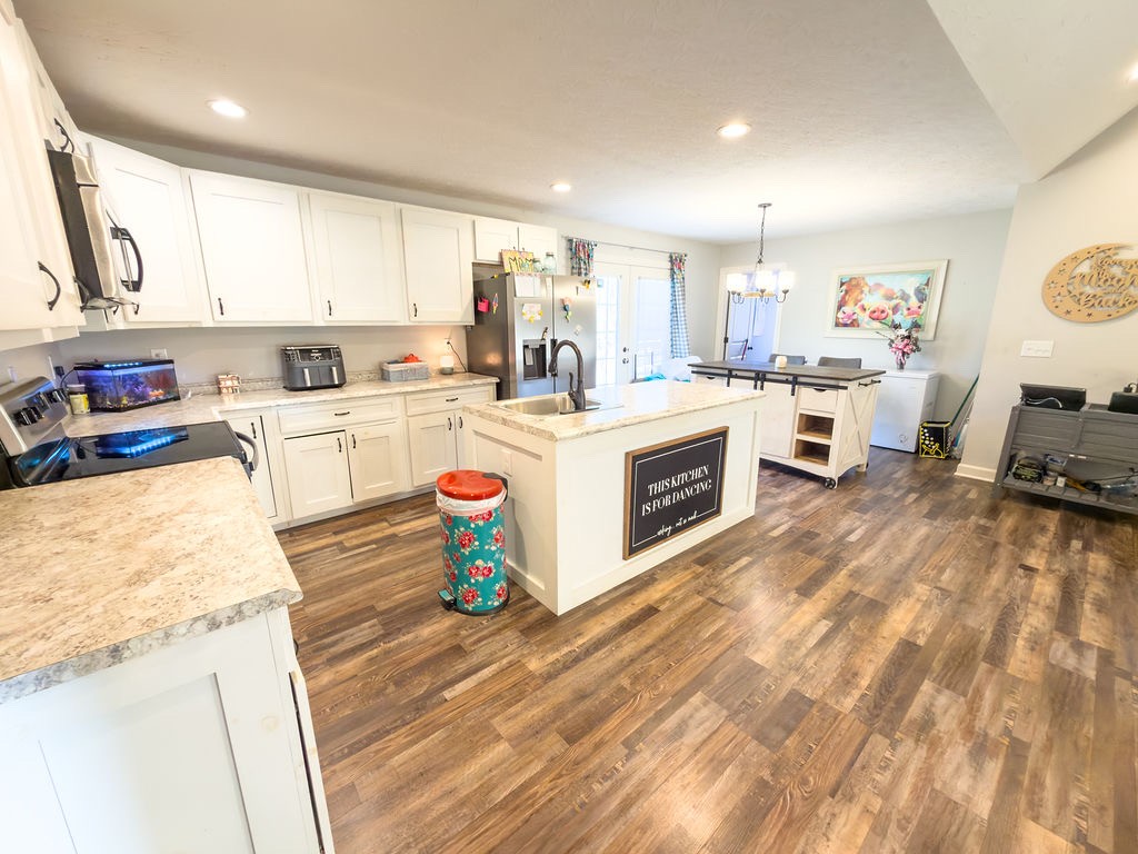 392 Scott Road Sharon Grove, KY 42280 - Photo 20 of 36 a kitchen with a stove top oven sink and a refrigerator