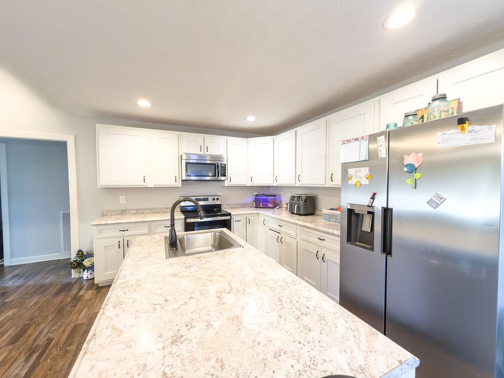 392 Scott Road Sharon Grove, KY 42280 - Photo 22 of 36 a kitchen with refrigerator a microwave a sink and cabinets