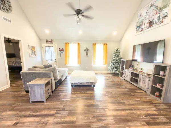 a living room with furniture and a flat screen tv