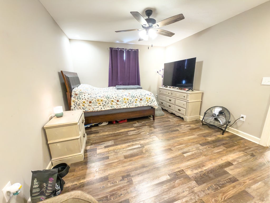 392 Scott Road Sharon Grove, KY 42280 - Photo 3 of 36 a spacious bedroom with a bed and a flat screen tv