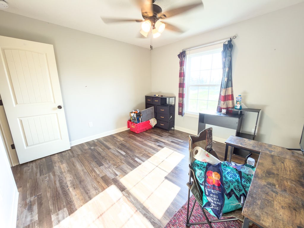 392 Scott Road Sharon Grove, KY 42280 - Photo 35 of 36 a bedroom with a bed wooden floor and a window