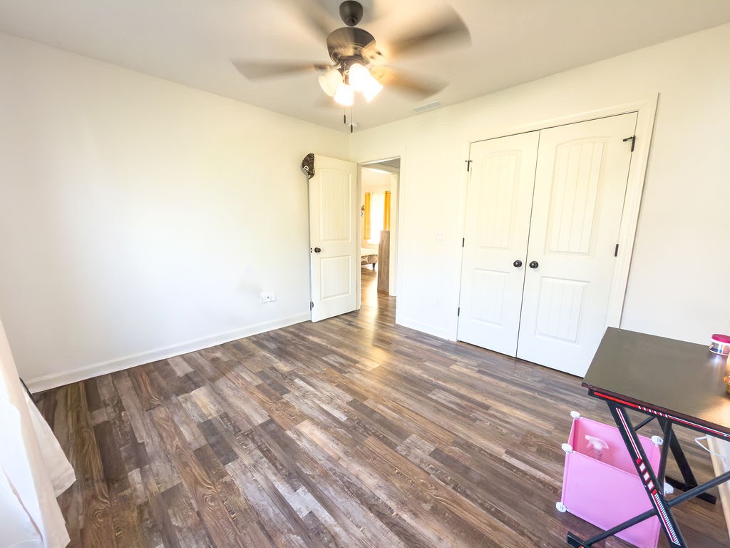 392 Scott Road Sharon Grove, KY 42280 - Photo 4 of 36 a view of a room with wooden floor and a ceiling fan