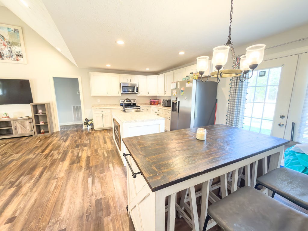 392 Scott Road Sharon Grove, KY 42280 - Photo 6 of 36 a view of a kitchen with kitchen island a counter space a sink appliances and a living room