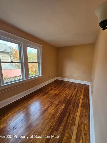 a view of wooden floor and windows in a room