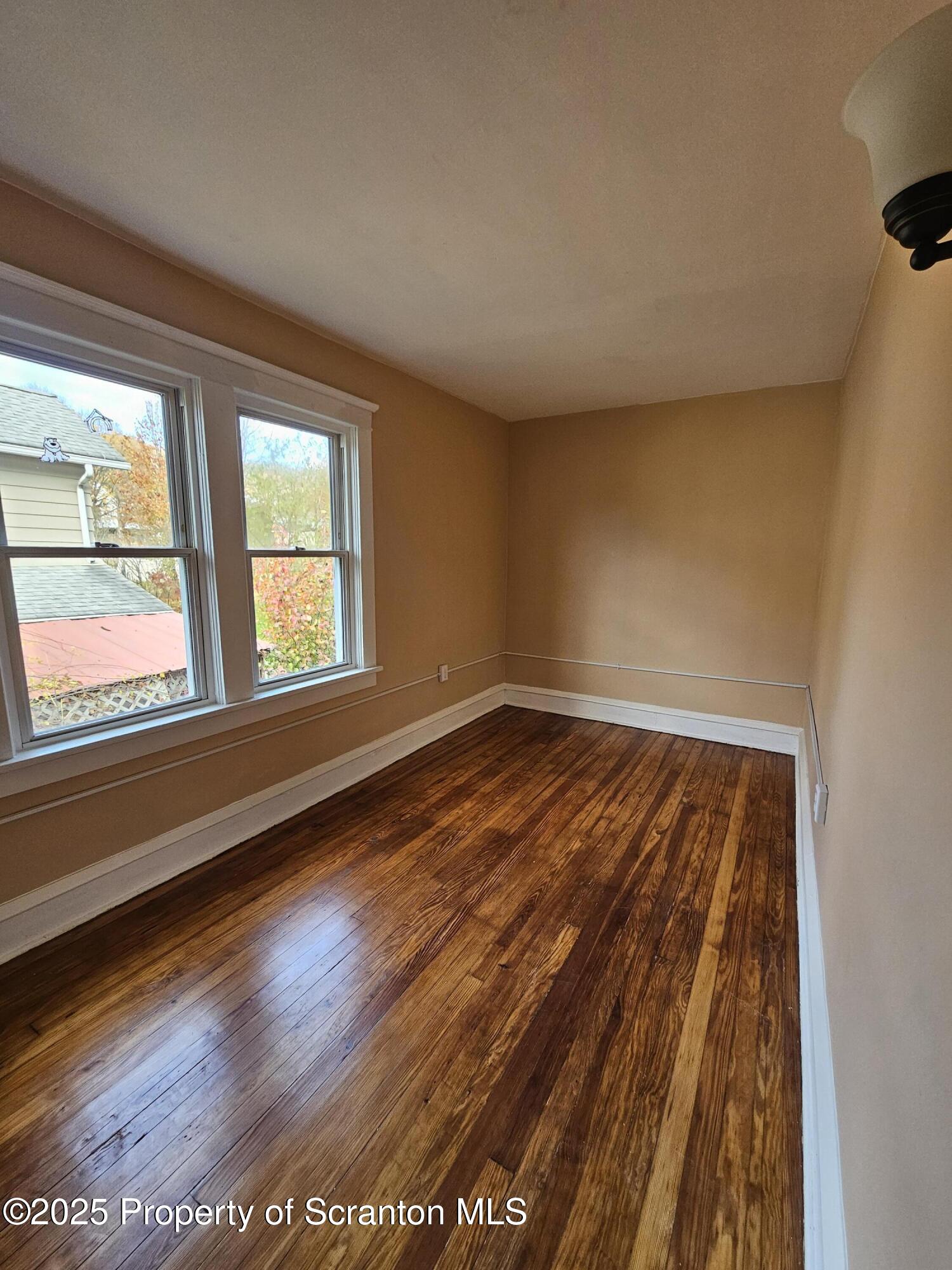 777 Bennett Street Luzerne, PA 18709 - Photo 11 of 17 a view of wooden floor and windows in a room