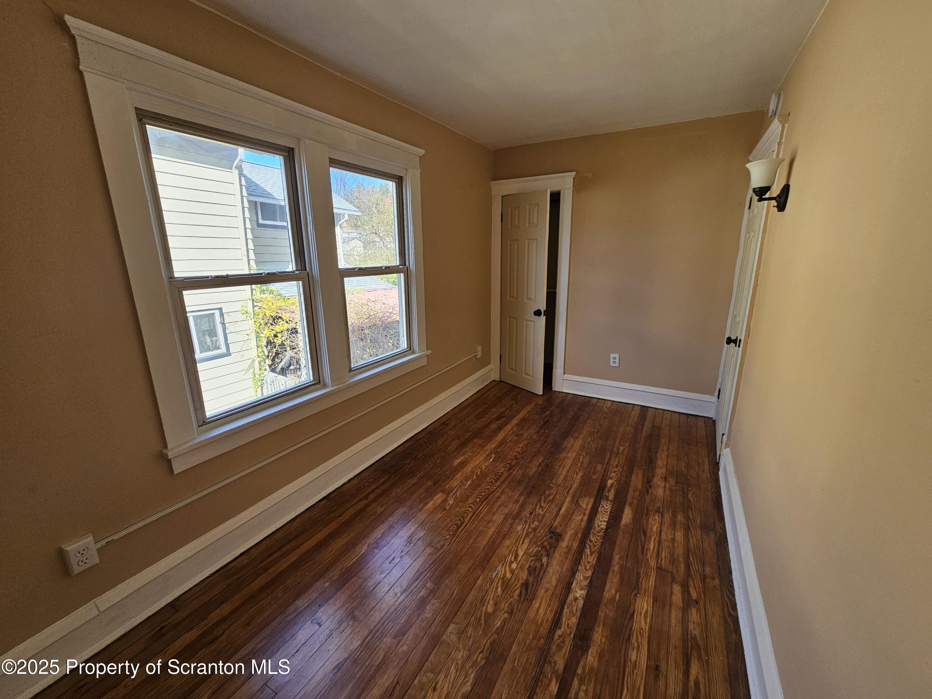 777 Bennett Street Luzerne, PA 18709 - Photo 13 of 17 a view of an empty room with wooden floor and a window
