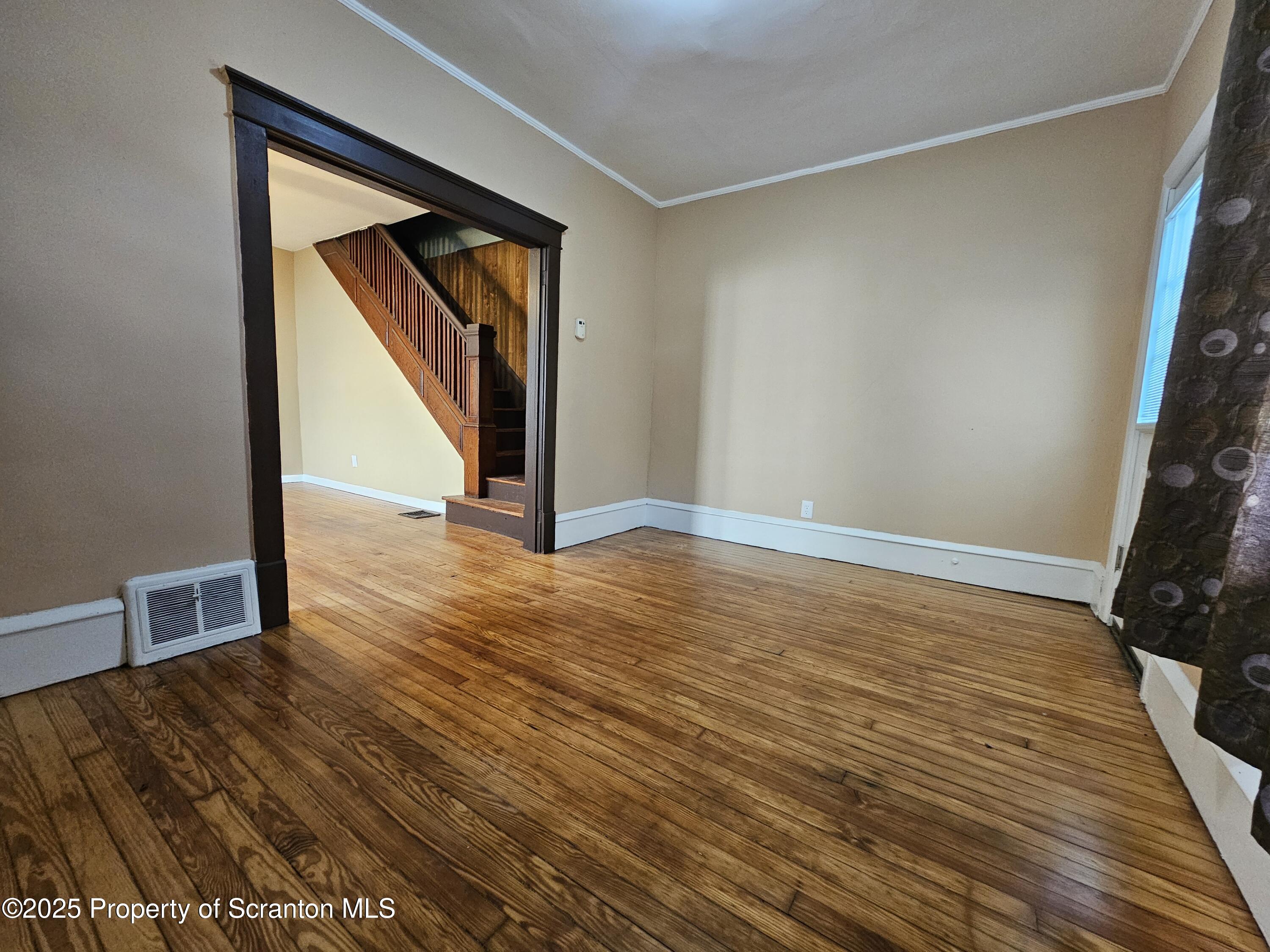 777 Bennett Street Luzerne, PA 18709 - Photo 3 of 17 a view of an empty room with wooden floor and a window