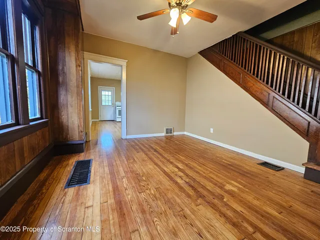 a view of a room with wooden floor