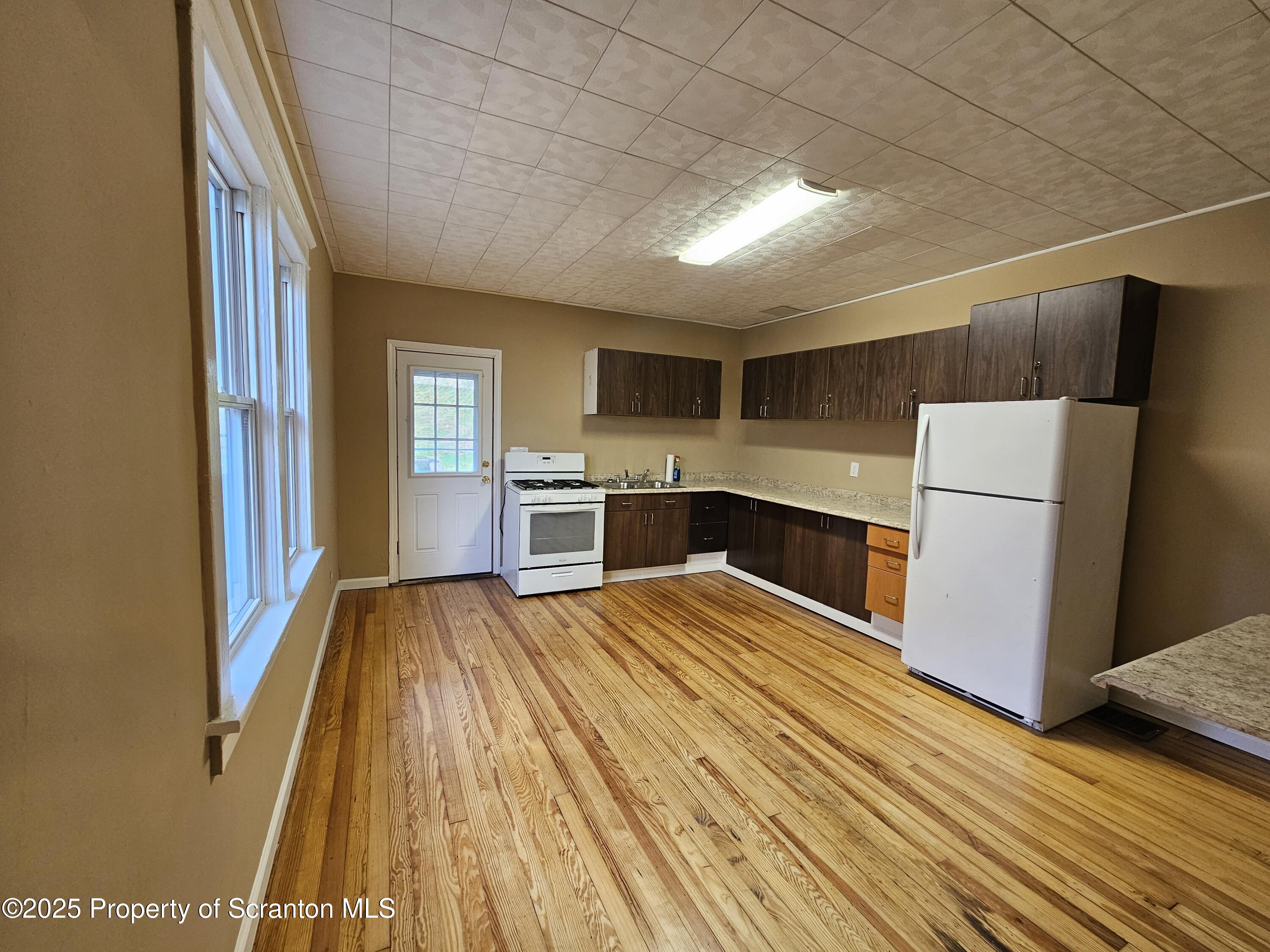 777 Bennett Street Luzerne, PA 18709 - Photo 7 of 17 a kitchen with a refrigerator and a stove top oven