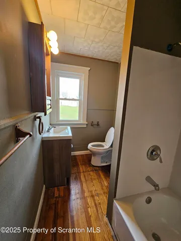 a bathroom with a sink a toilet and bathtub