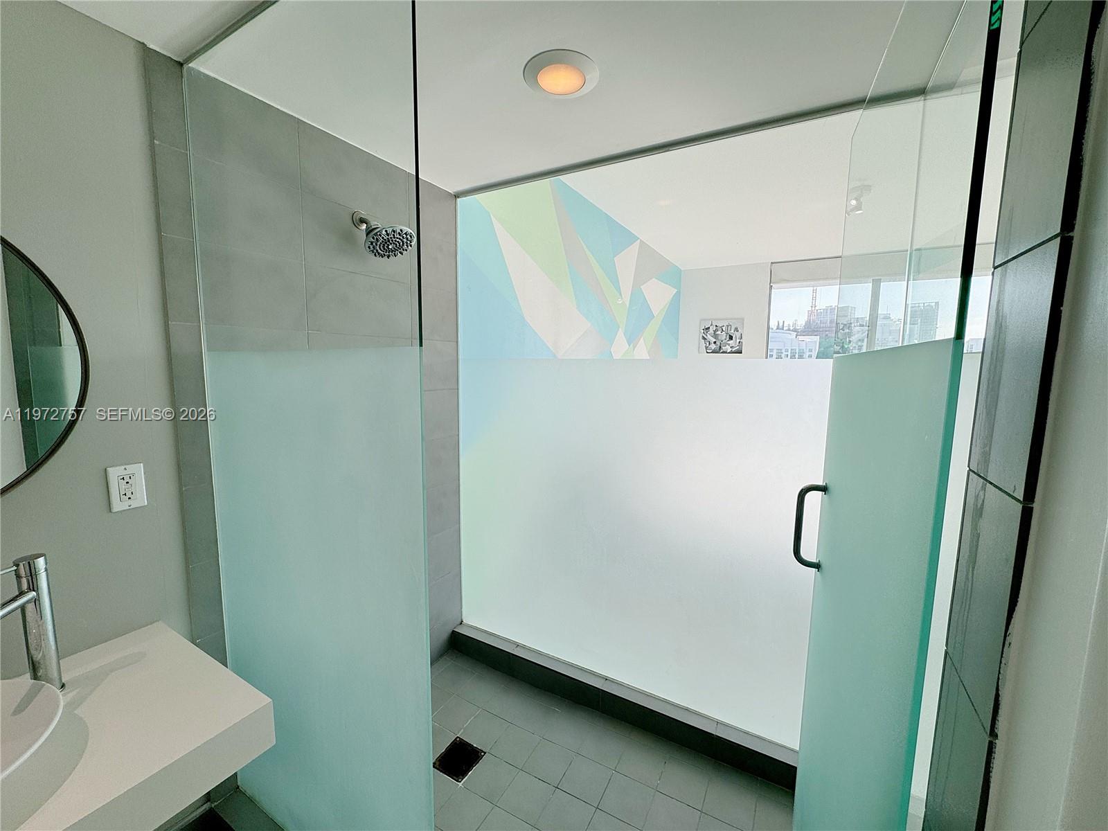 92 Southwest 3rd Street, Unit 3912 Miami, FL 33130 - Photo 18 of 33 a bathroom with a shower and a sink