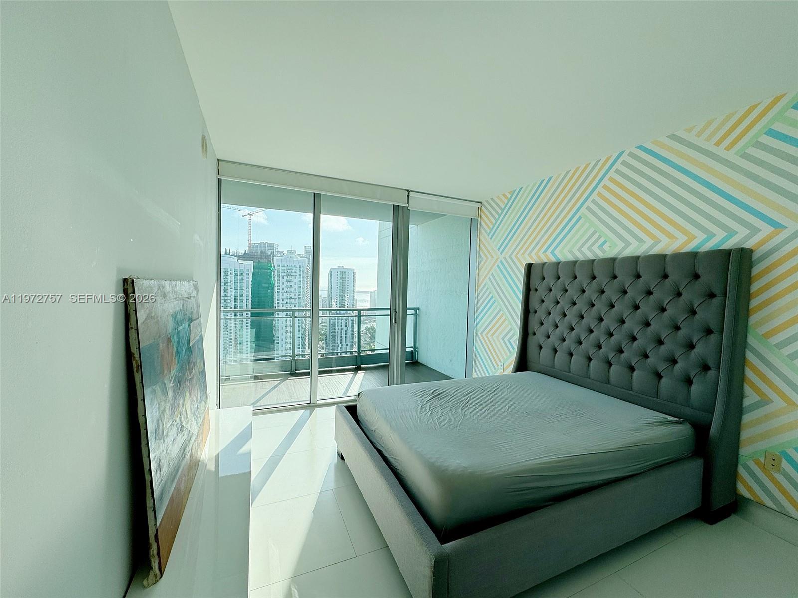 92 Southwest 3rd Street, Unit 3912 Miami, FL 33130 - Photo 24 of 33 a bedroom with a bed and a window