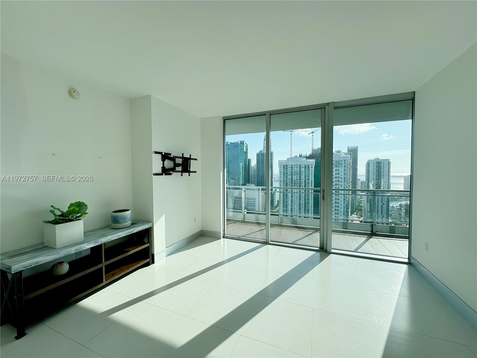 92 Southwest 3rd Street, Unit 3912 Miami, FL 33130 - Photo 5 of 33 a spacious bedroom with a bed and large windows