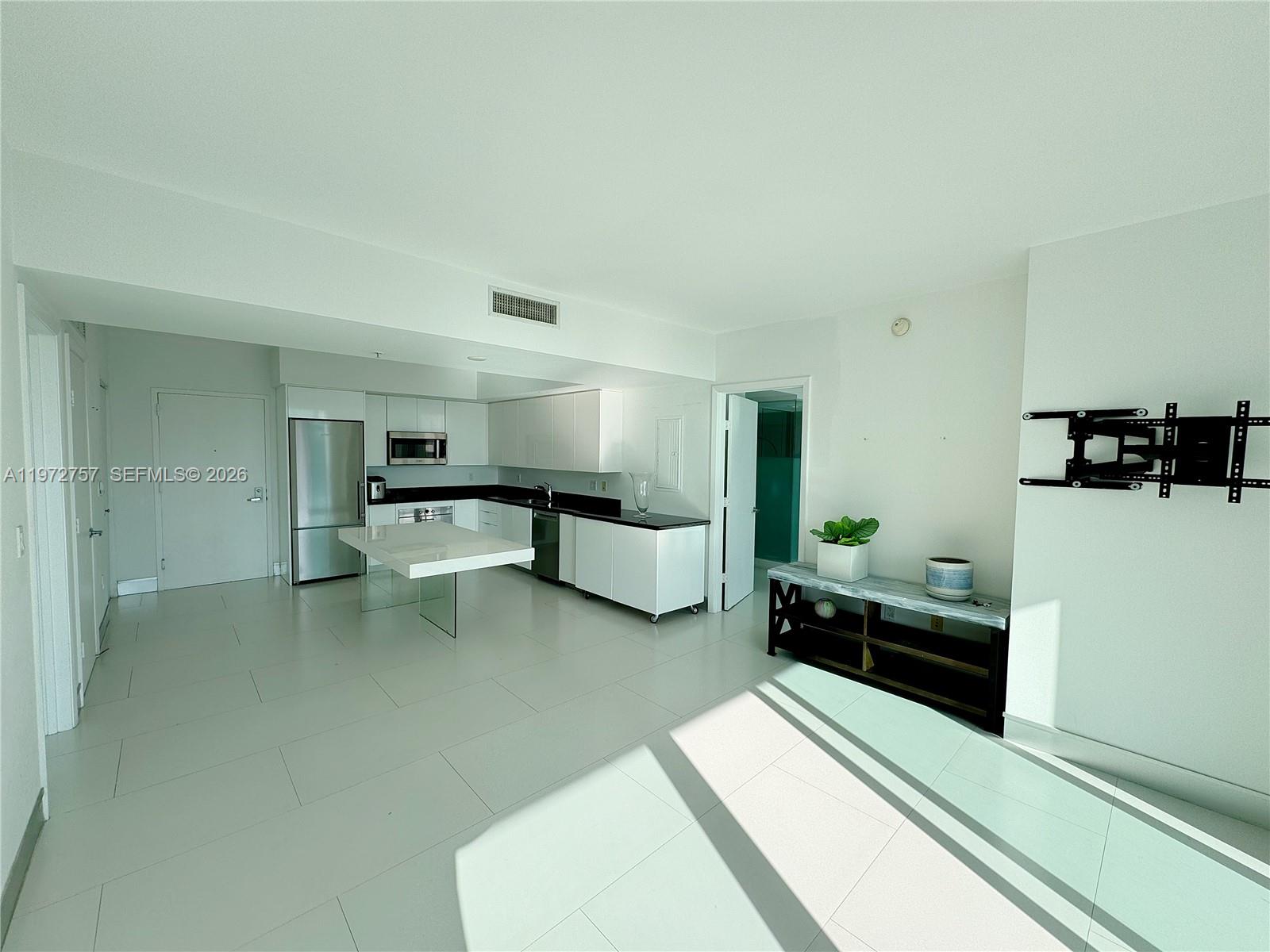 92 Southwest 3rd Street, Unit 3912 Miami, FL 33130 - Photo 6 of 33 a living room with furniture and a refrigerator