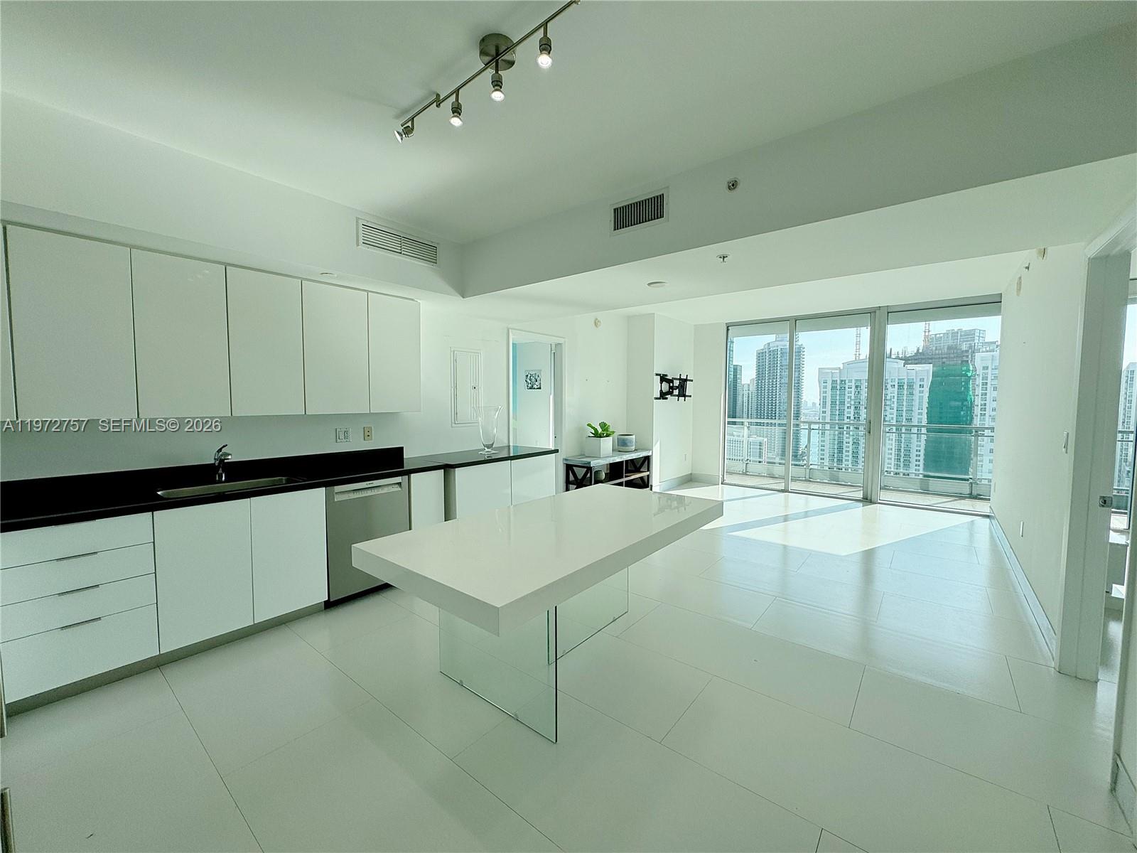 92 Southwest 3rd Street, Unit 3912 Miami, FL 33130 - Photo 7 of 33 a kitchen with a sink and cabinets