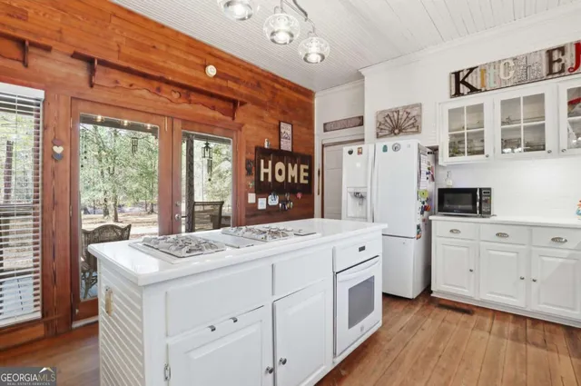 a view of a kitchen counter top space with stainless steel appliances granite countertop furniture and a large window
