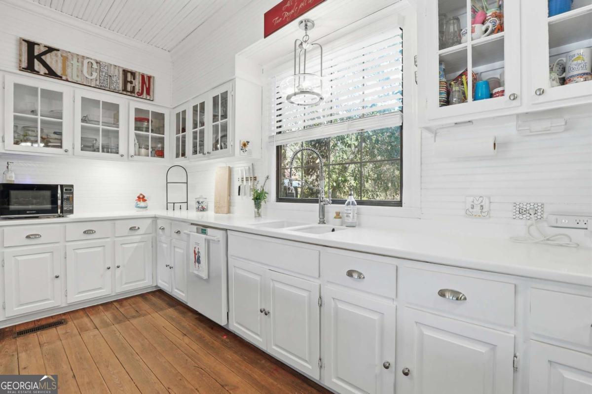 4931 Mill Branch Hunting Clb Road Pembroke, GA 31321 - Photo 16 of 71 a kitchen with cabinets stainless steel appliances a sink and a window