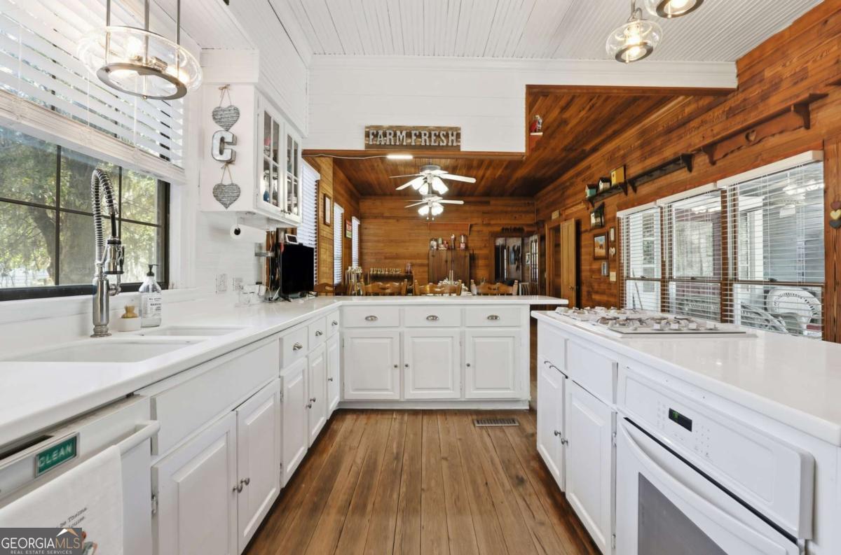 4931 Mill Branch Hunting Clb Road Pembroke, GA 31321 - Photo 18 of 71 a large white kitchen with a large window