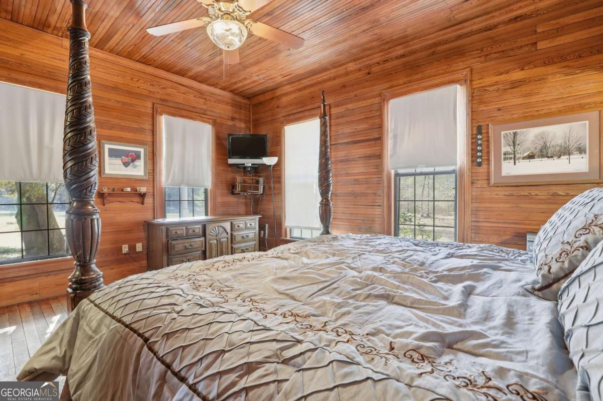 4931 Mill Branch Hunting Clb Road Pembroke, GA 31321 - Photo 20 of 71 a bed sitting in a bedroom next to a window