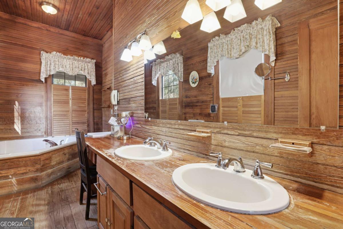 4931 Mill Branch Hunting Clb Road Pembroke, GA 31321 - Photo 26 of 71 a bathroom with a sink and a mirror