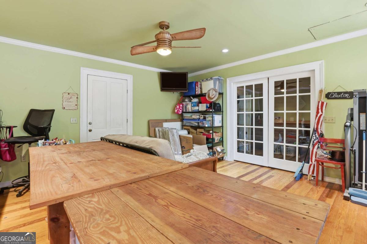4931 Mill Branch Hunting Clb Road Pembroke, GA 31321 - Photo 27 of 71 a bedroom with a bed and a large window