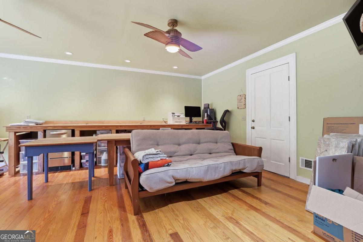 4931 Mill Branch Hunting Clb Road Pembroke, GA 31321 - Photo 28 of 71 a living room with furniture and a wooden floor