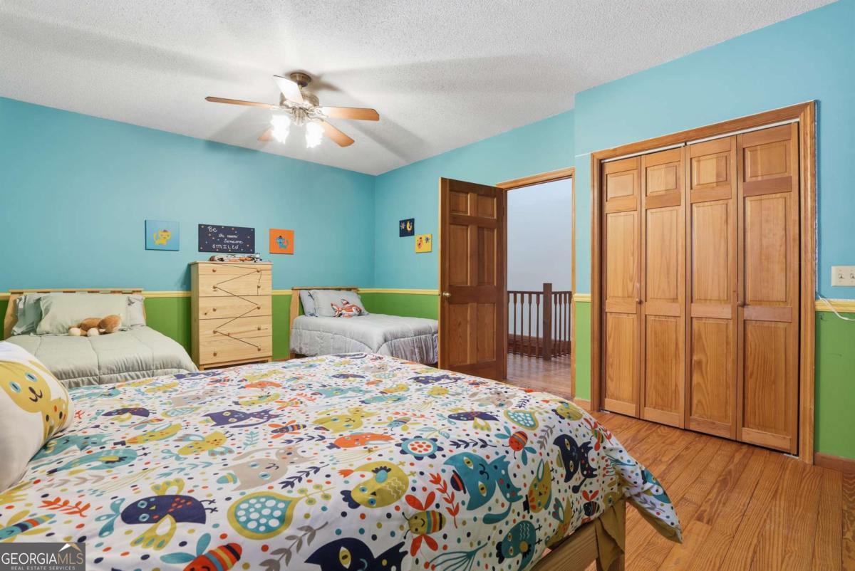 4931 Mill Branch Hunting Clb Road Pembroke, GA 31321 - Photo 36 of 71 a bedroom with a bed and a chandelier