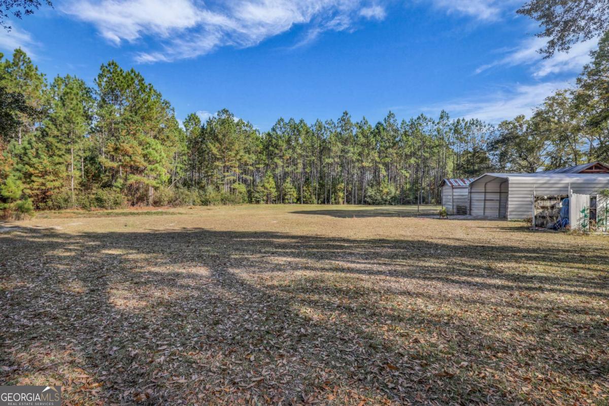 4931 Mill Branch Hunting Clb Road Pembroke, GA 31321 - Photo 46 of 71 a view of a house with a yard