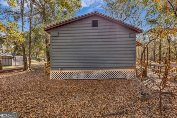 a view of a house with backyard porch and sitting area