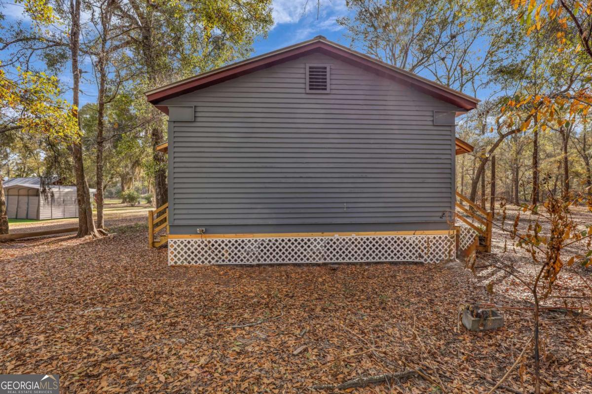 4931 Mill Branch Hunting Clb Road Pembroke, GA 31321 - Photo 48 of 71 a side view of a house