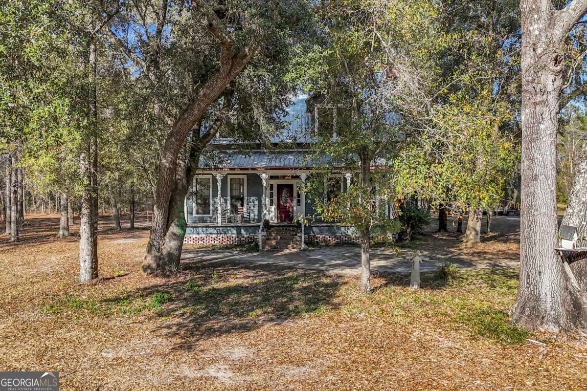 4931 Mill Branch Hunting Clb Road Pembroke, GA 31321 - Photo 68 of 71 a view of a house with backyard porch and sitting area