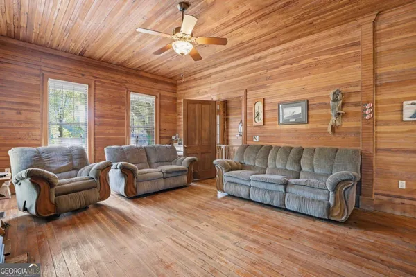 a view of a balcony with furniture and wooden floor
