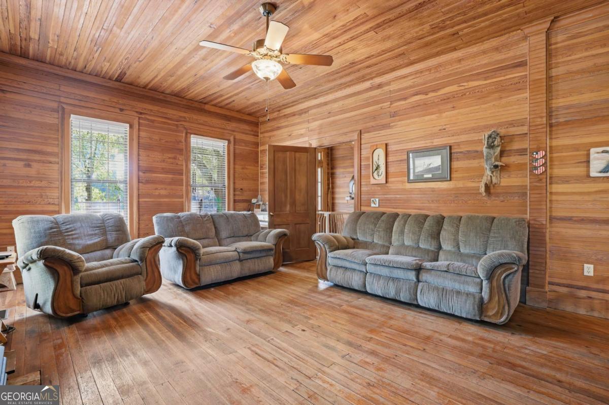 4931 Mill Branch Hunting Clb Road Pembroke, GA 31321 - Photo 8 of 71 a living room with furniture and a large window