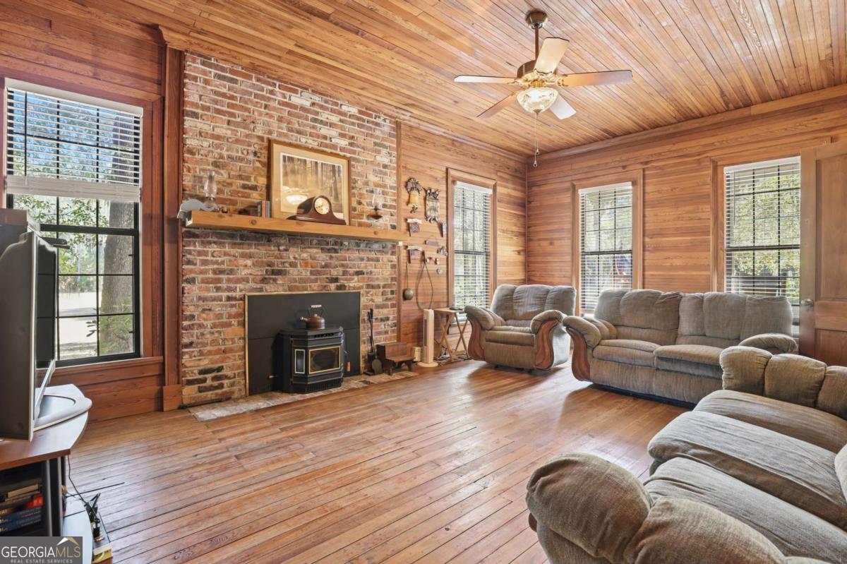 4931 Mill Branch Hunting Clb Road Pembroke, GA 31321 - Photo 9 of 71 a living room with furniture and a fireplace