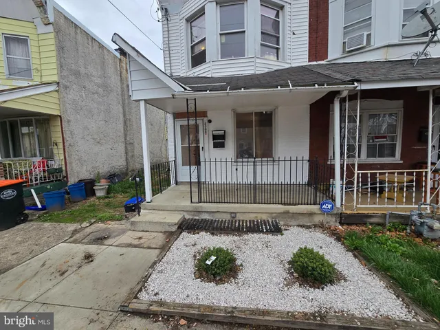 a view of a house with brick walls and a small yard