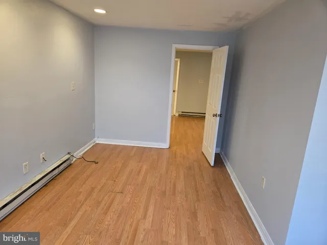 a view of a room with wooden floor and a gate