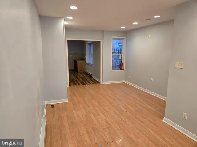 a view of hallway with wooden floor