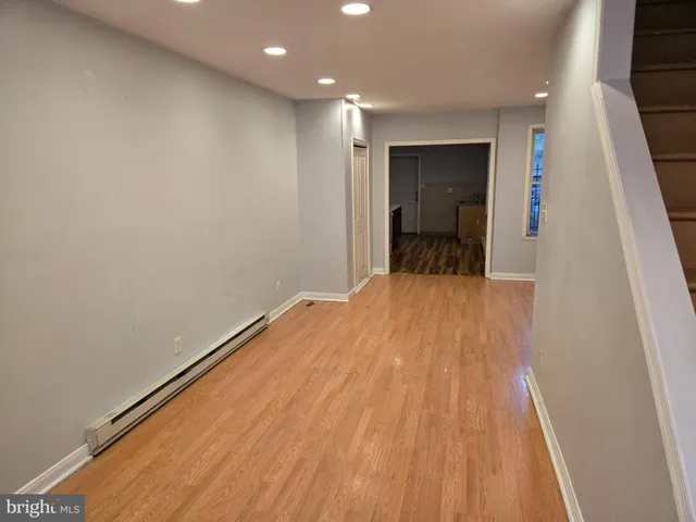 a view of a room with wooden floor