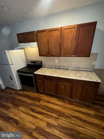 a view of kitchen with microwave and cabinets