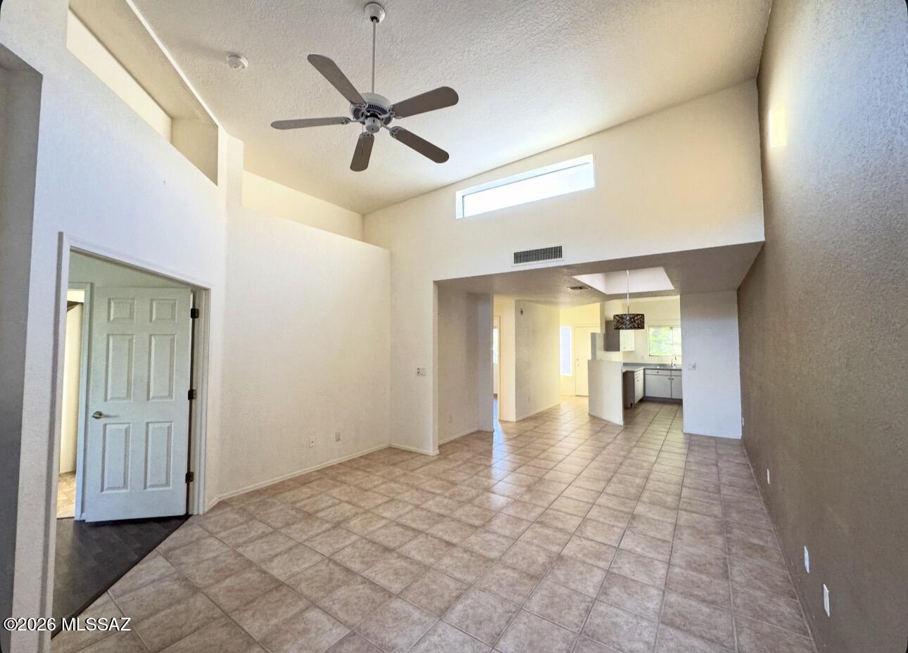 4998 North Valle Road Tucson, AZ 85750 - Photo 9 of 11 a view of a hallway with a dining table & chairs and a chandelier fan