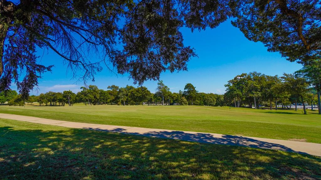2505 Wedglea Drive, Unit 121 Dallas, TX 75211 - Photo 22 of 24 a view of a golf course with a lake view