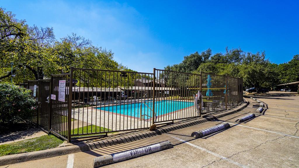 2505 Wedglea Drive, Unit 121 Dallas, TX 75211 - Photo 24 of 24 a view of a park with a bench and trees