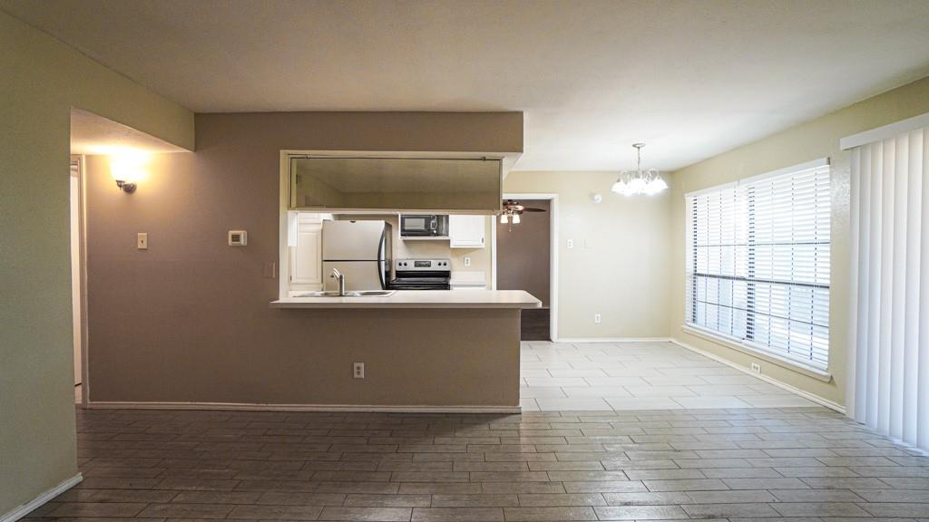 2505 Wedglea Drive, Unit 121 Dallas, TX 75211 - Photo 8 of 24 a view of a kitchen with a sink and a window