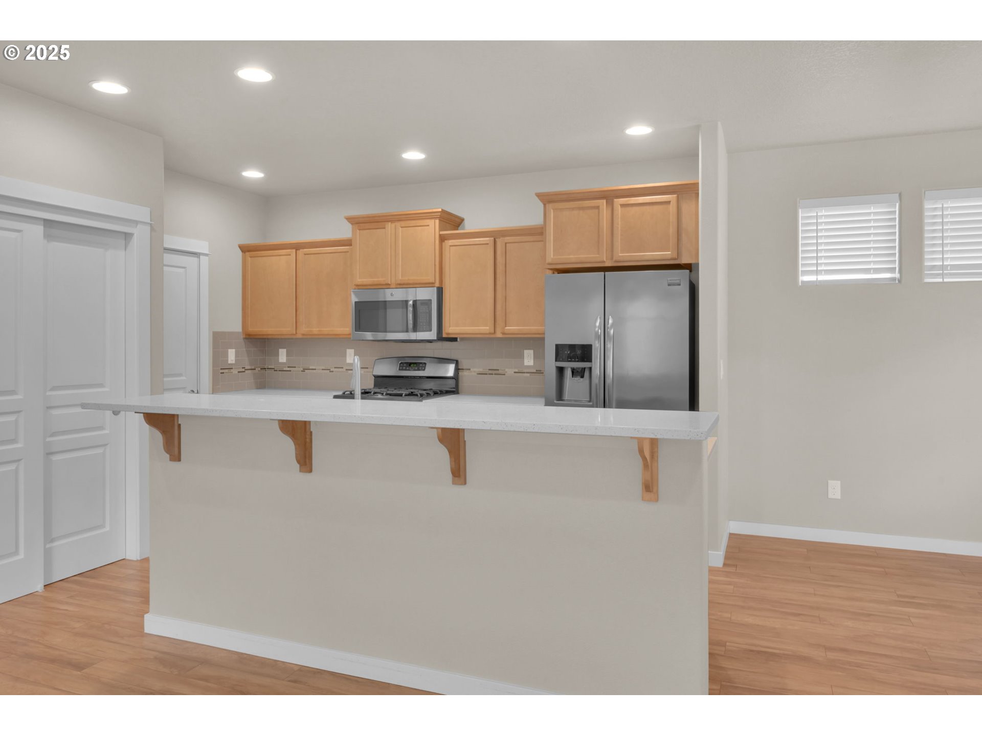 3015 Guadalupe Way Eugene, OR 97408 - Photo 17 of 48 a kitchen with kitchen island granite countertop cabinets and refrigerator