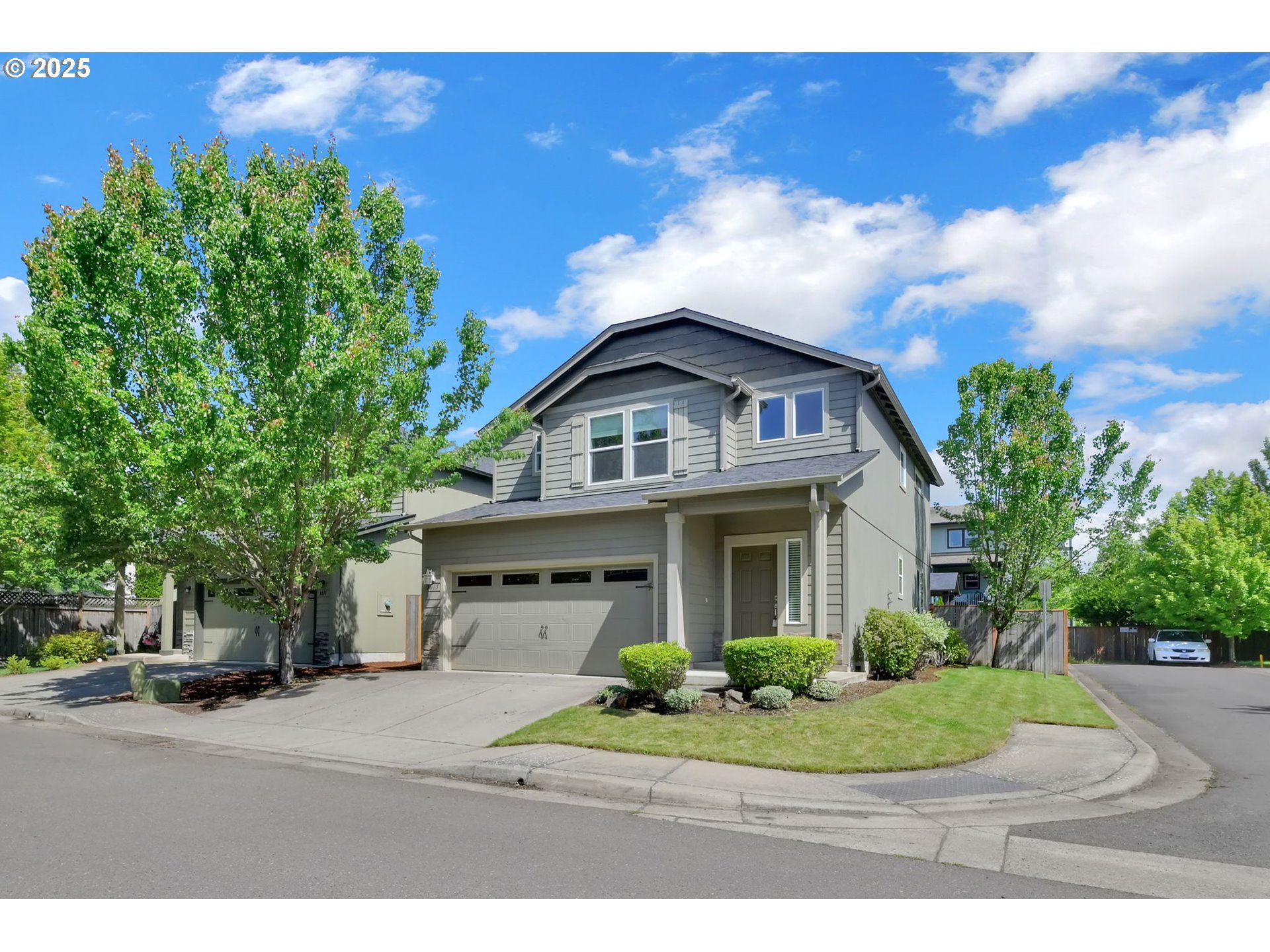 3015 Guadalupe Way Eugene, OR 97408 - Photo 2 of 48 a view of a white house next to a yard with big trees
